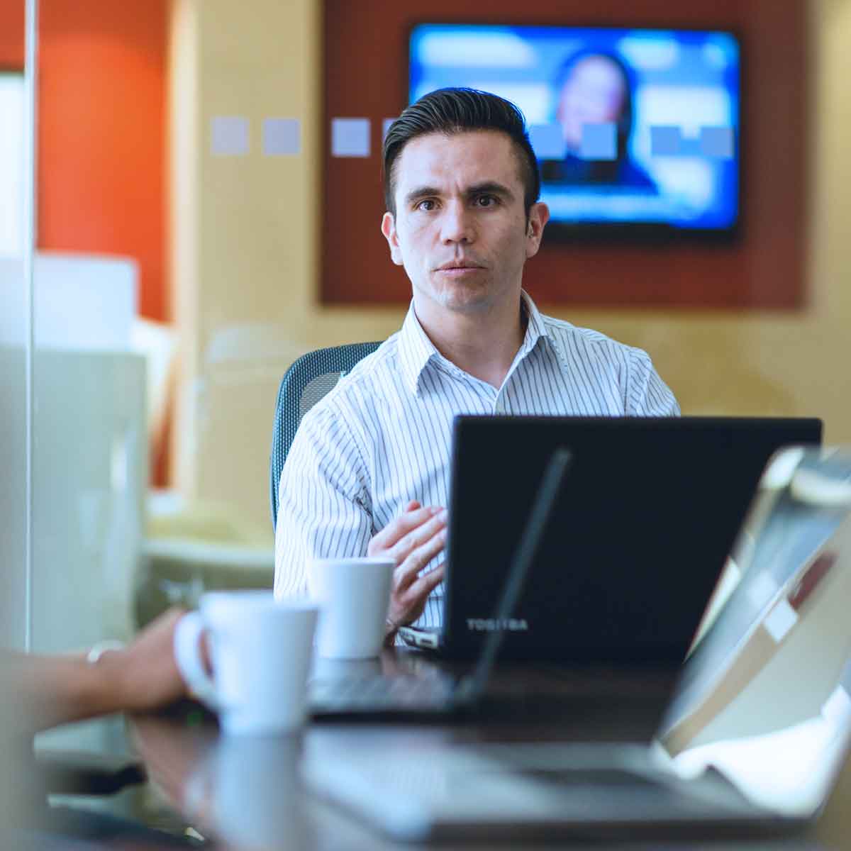 Professional at desk looking at camera